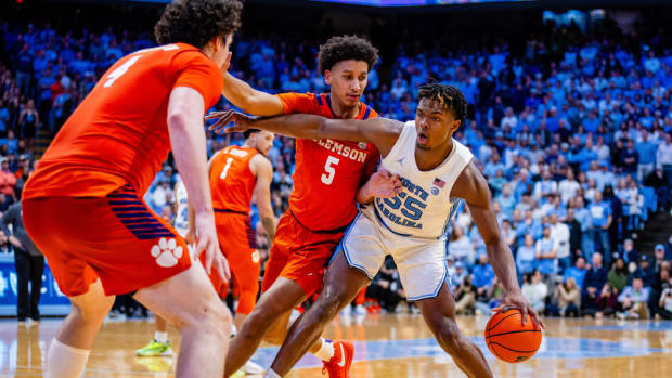 Clemson players defend North Carolina forward Harrison Ingram.